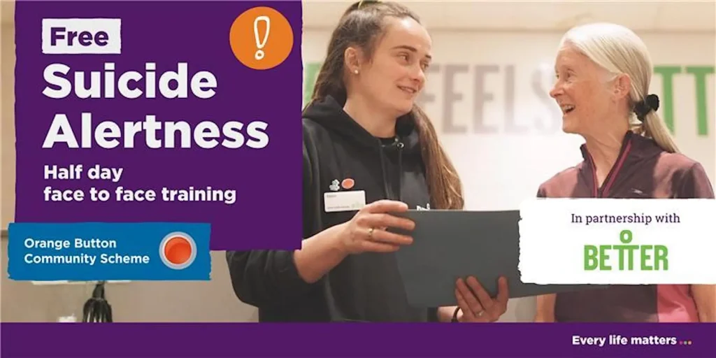 A graphic for the Suicide Alertness training, with white text on a purple background. There is a photo of two women. One has long brown hair and is wearing a black hood and holding a file or laptop. She is looking at a smiling lder lady with long white hair tied back and a brown and pink top.