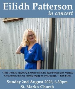 A graphic for the concert, with a photo of Eilidh stood against a corrugated metal building. She has long blonde hair, black glasses, and is wearing a blue dress. She is smiling, and has one hand behind her head.
